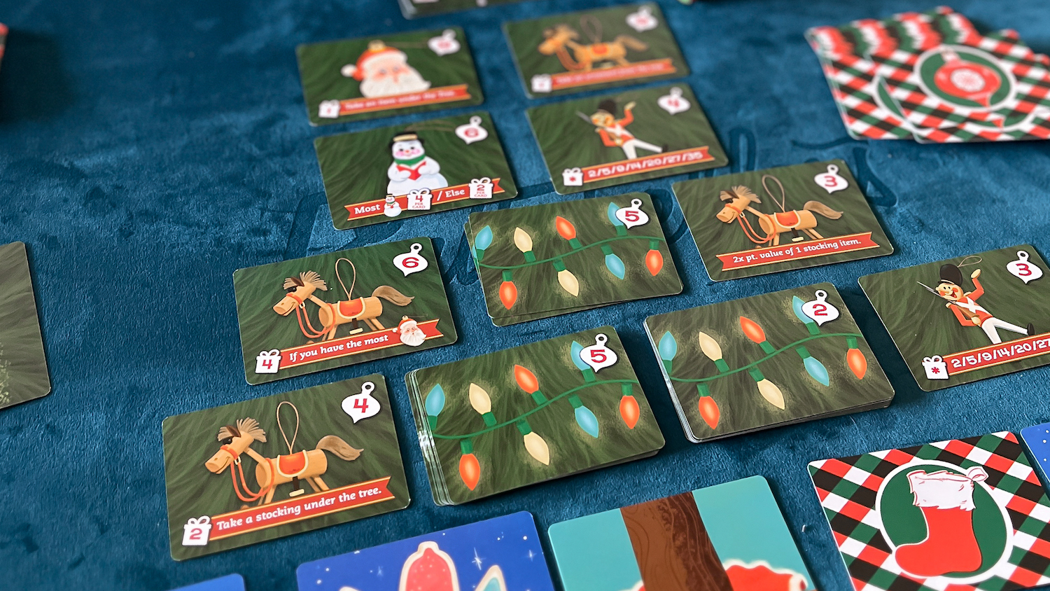 Collage of popular family board games including Ticket to Ride arranged on festive holiday table setting