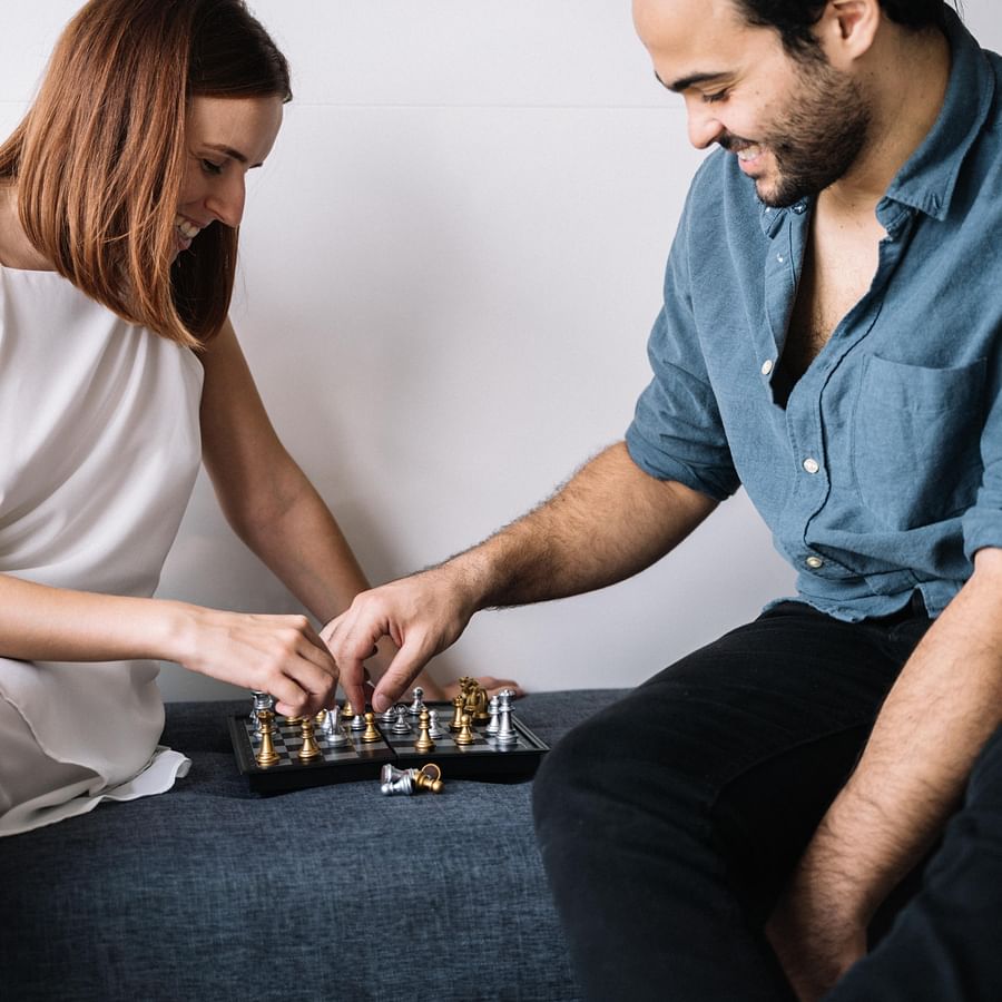 Happy couple engaged in a board game at home