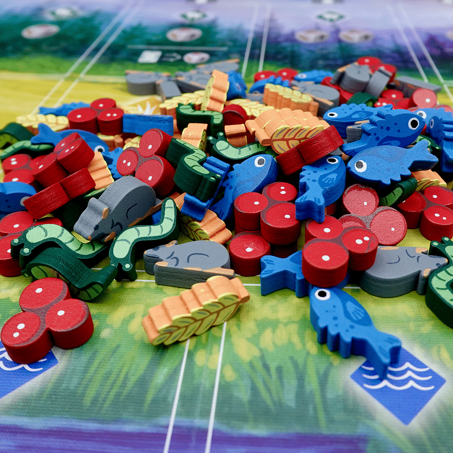 Colorful collage of various board game pieces and decks